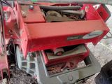 a small red machine that is sitting on the ground