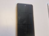 a cell phone sitting on a table next to a cell phone