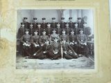 an old photo of a group of men in uniform posing for a picture
