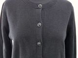 the back of a woman ' s gray sweater with buttons on it