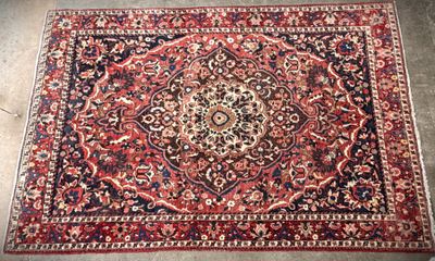 a red rug with a medallion design on top of it