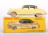 yellow toy car sitting on top of a yellow box on a white surface