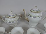many cups and saucers sitting next to each other