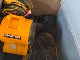 a yellow blower sitting inside of a metal container
