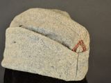 grey wool cap with red stitchs on top of a mannequin ' s head