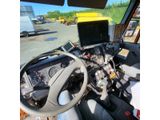 a view of the inside of a truck from the driver ' s seat