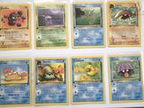 a lot of pokemon cards that are on the table