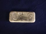a gold bar on a blue cloth