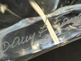 a close up of a glass vase with a toothpick in it