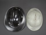two hard hats sitting next to each other on a table