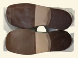 two pairs of shoes that are on a white surface
