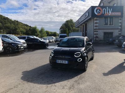 many cars parked in a parking lot in front of a building