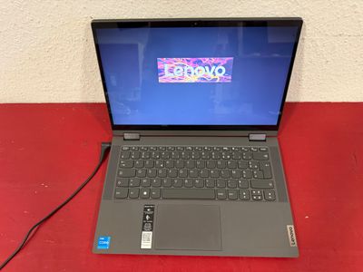 an open laptop computer sitting on top of a red table