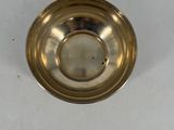 a silver plate with a gold rim on a white table