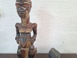 two figurines of a man and a dog sitting on a table