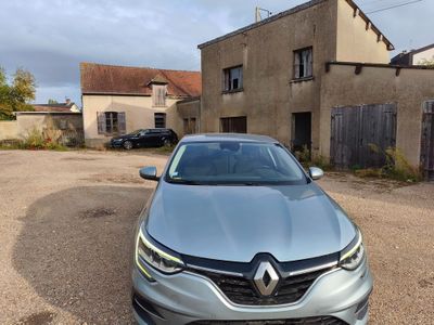 the front of a silver car parked in front of a building
