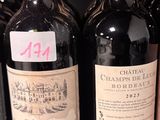 several bottles of wine are lined up on a shelf in a store