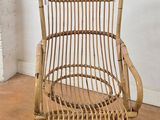 a wicker chair and ottoman in the corner of a room