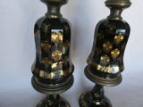 two black and gold vases with gold designs on them