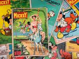 a lot of disney comics on the table