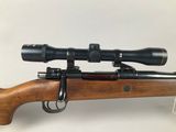 a rifle with a scope mounted on top of it