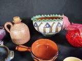 many different types of pottery on a black table