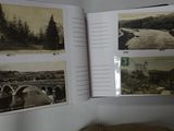 a book open to a picture of a river and a bridge