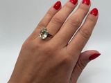 the hand of a woman with red nails and a ring on her finger