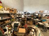 a man standing in the middle of a room filled with lots of boxes