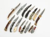 many different types of knives on a white surface