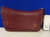 a red leather purse with gold hardware on the front and side