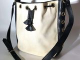 an image of a white and black bag with a bow on it