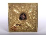 brass square with a hole in the middle and a small square in the middle of it