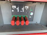 a red machine with four red knobs on it
