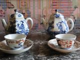 three cups and saucers sitting on a table