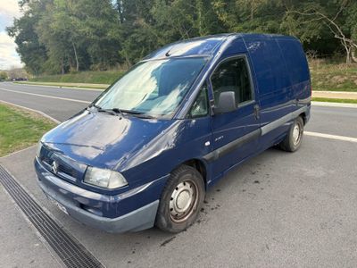 a blue van that is parked on the side of the road