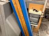 several pieces of wood are stacked on top of a refrigerator in a room
