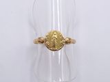 a close up of a ring with a gold coin on it