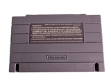 an old nintendo game console sitting on top of a white surface
