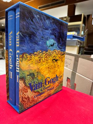 the book van gogh is sitting on a red table cloth