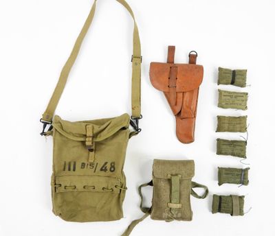 the contents of a military bag are laid out on a white surface