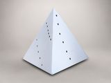 a close up of a white paper pyramid with holes in it