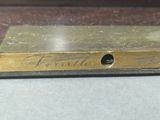 a gold plate with writing on it sitting on a table