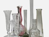 a lot of glass vases that are sitting on a table