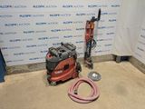 a machine that is sitting on the floor next to a hose