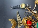 a lot of gold jewelry on a black table