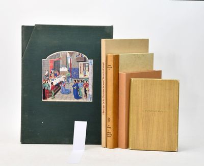 three books sitting on top of each other on a table