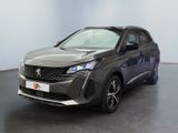 the front view of a dark colored car parked in a room