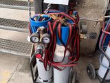 two oxygen cylinders with hoses attached to them