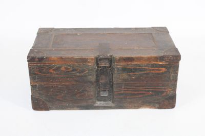 an old wooden box sitting on top of a white surface